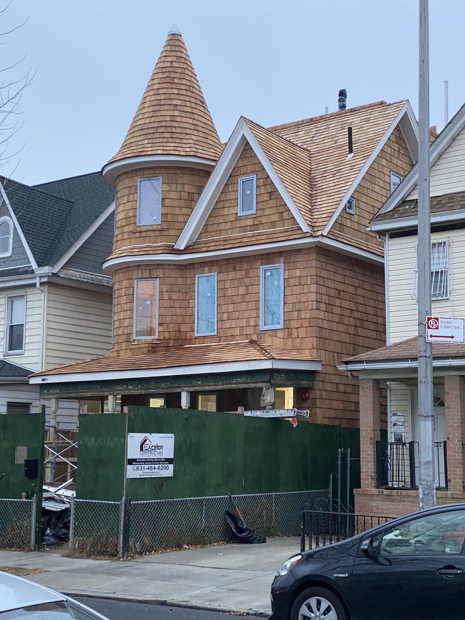 Restored cedar shingle facade on a Victorian wood-frame home in Kensington, Brooklyn, with carved trim and original architectural detail