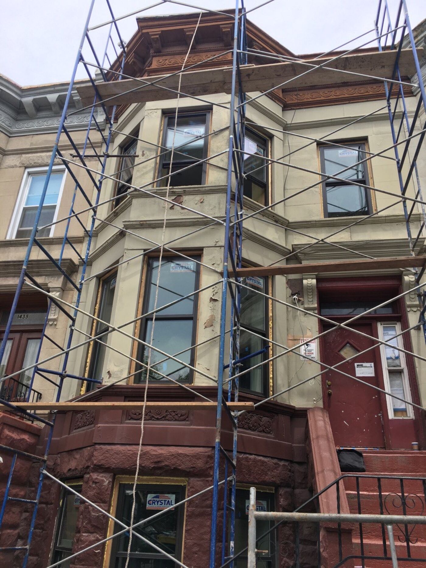 Restored limestone facade with painted finish.
